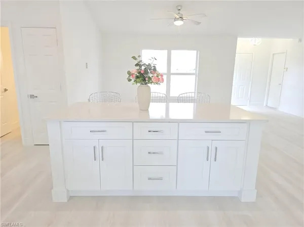 a bathroom with white cabinets