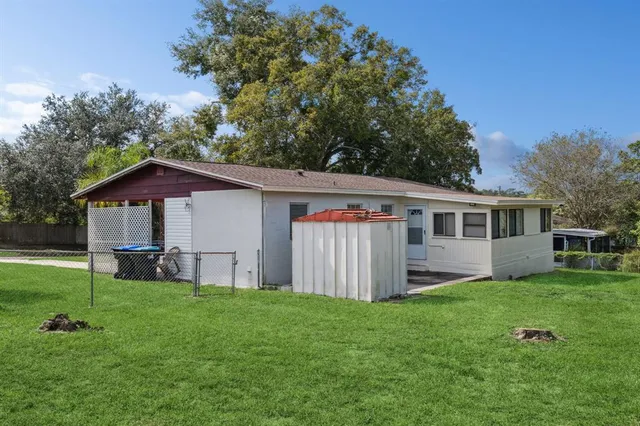 a view of a house with a yard and sitting area