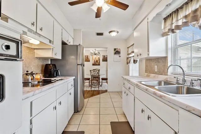 a kitchen with stainless steel appliances granite countertop a sink and cabinets