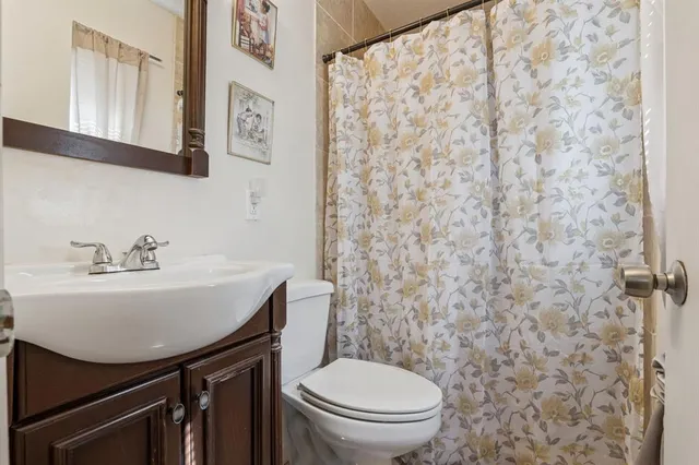 a bathroom with a sink a toilet and a mirror