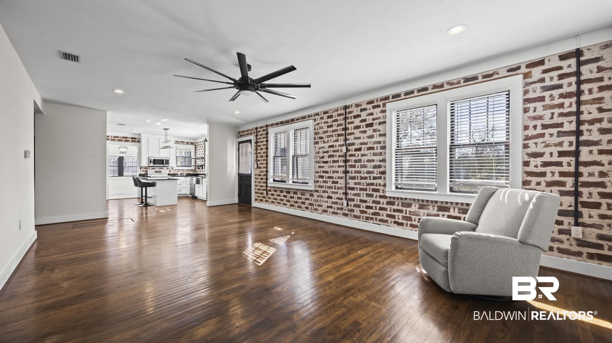 24701 Highway 98 Elberta, AL 36530 - Photo 11 of 32 Sitting room featuring dark wood-type flooring, brick wall, recessed lighting, and ceiling fan