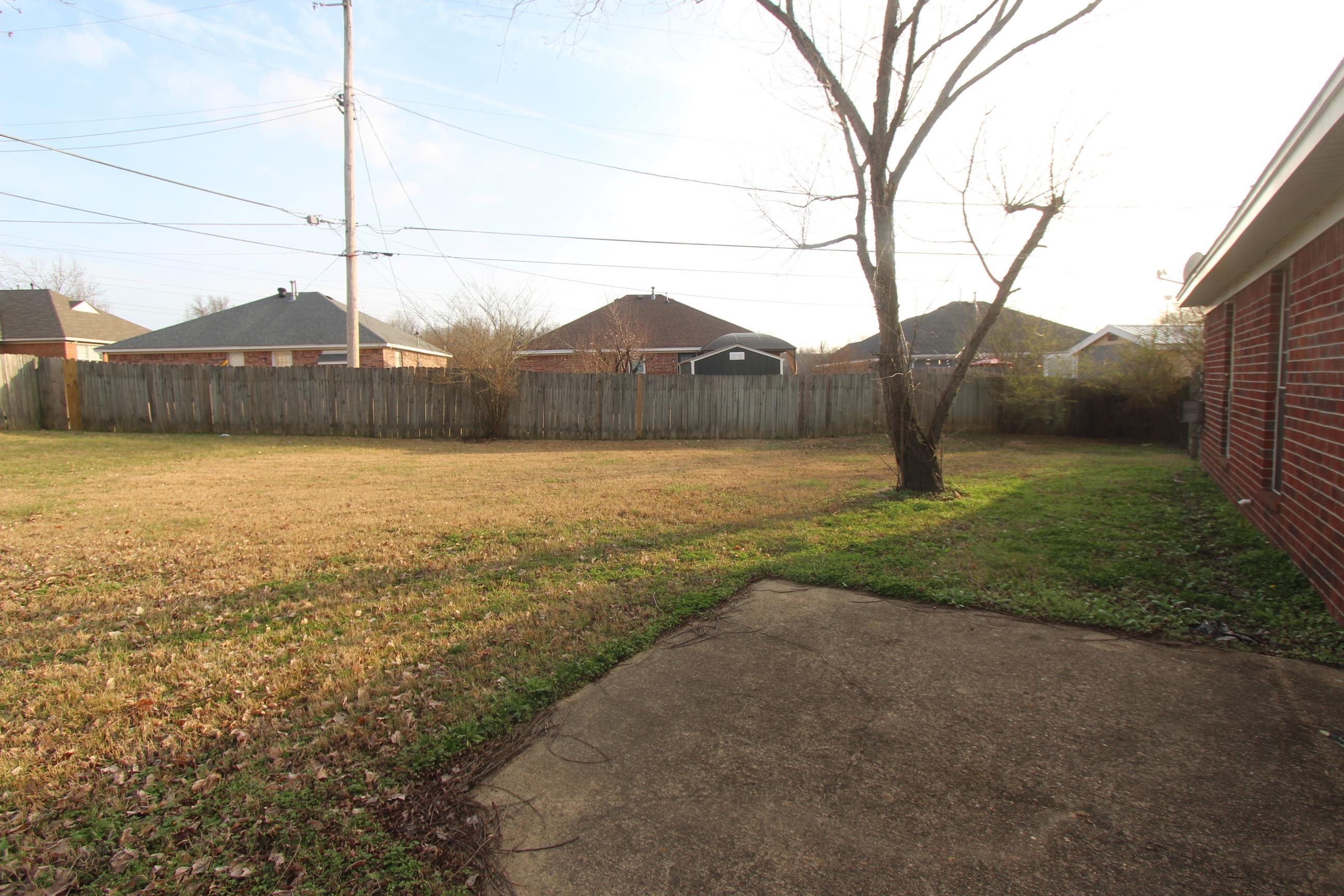 4563 Cedargreen Cove Memphis, TN 38128 - Photo 11 of 12 a view of a yard with a house and a large tree