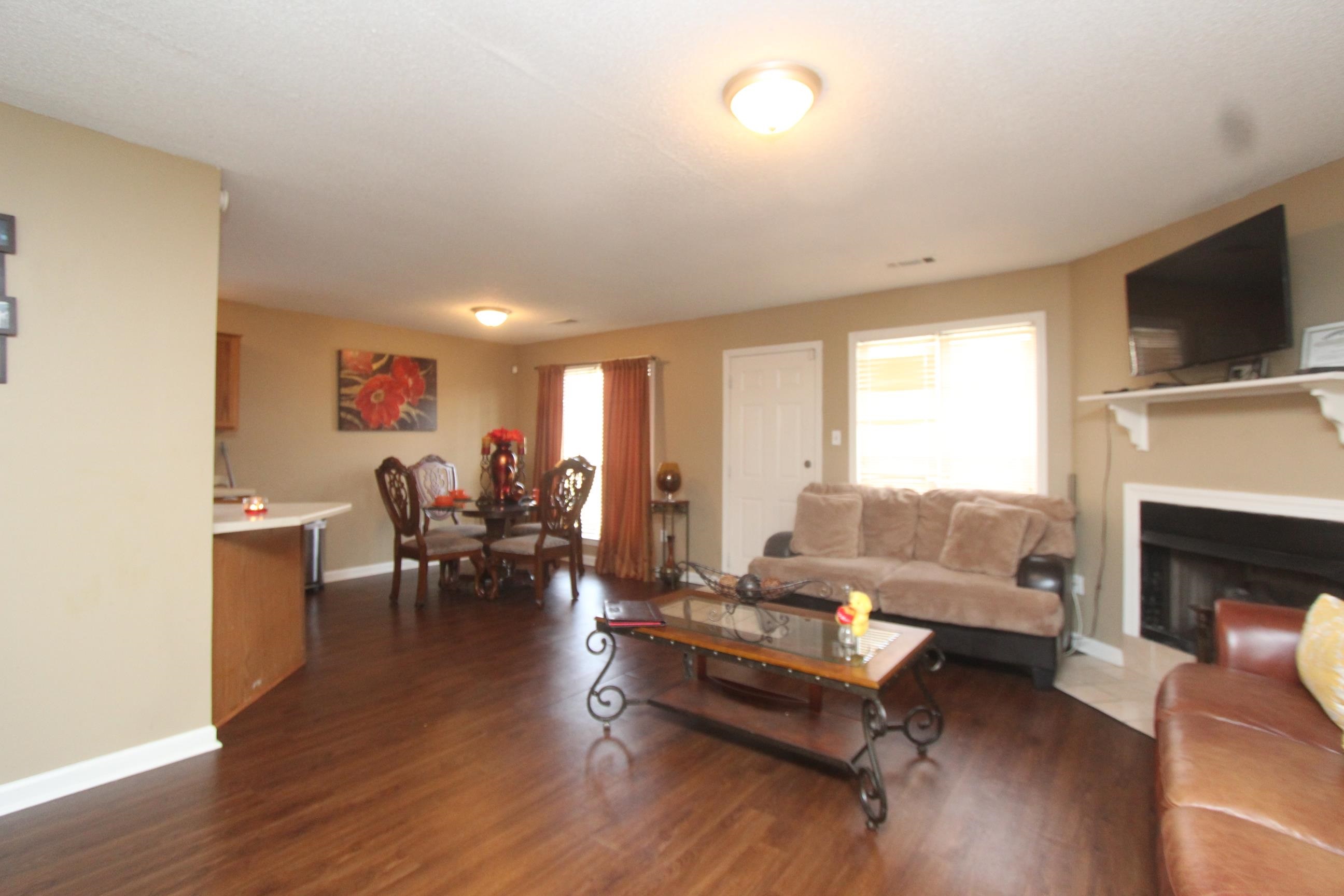 4563 Cedargreen Cove Memphis, TN 38128 - Photo 4 of 12 a living room with furniture fireplace and flat screen tv
