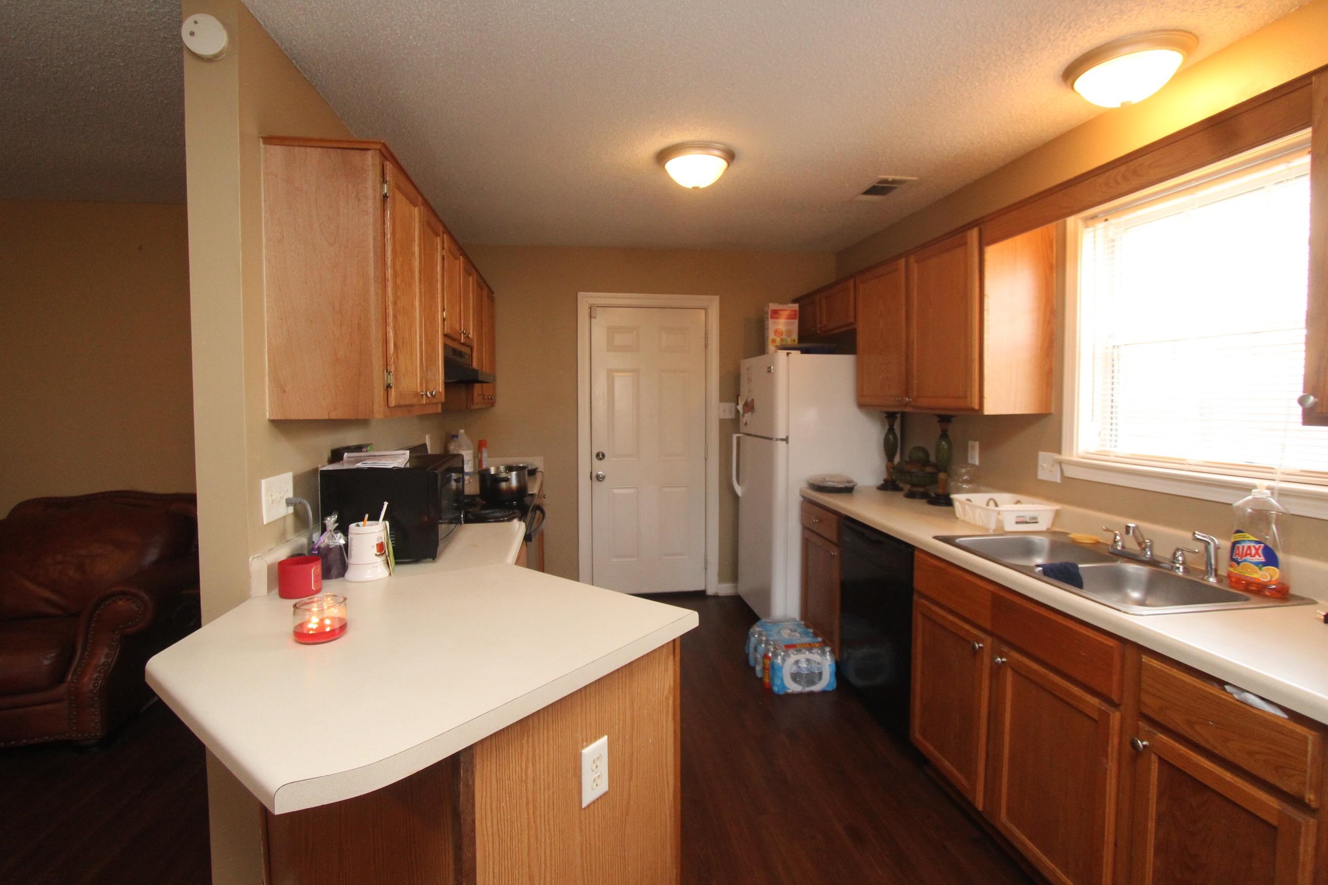 4563 Cedargreen Cove Memphis, TN 38128 - Photo 6 of 12 a kitchen with a sink a stove a refrigerator and cabinets