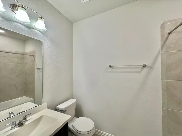 a white toilet sitting next to a bathroom sink