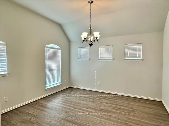 a view of livingroom with chandelier fan and wooden floor