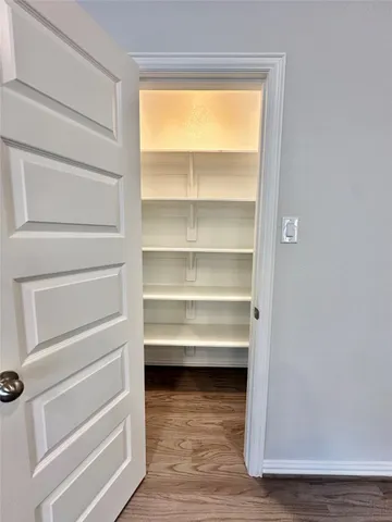 a view of walk in closet with empty racks