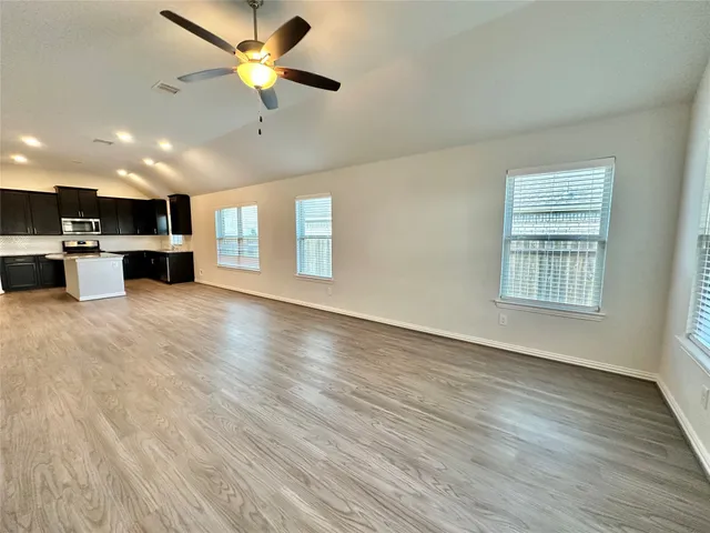 a view of kitchen with stove and cabinets