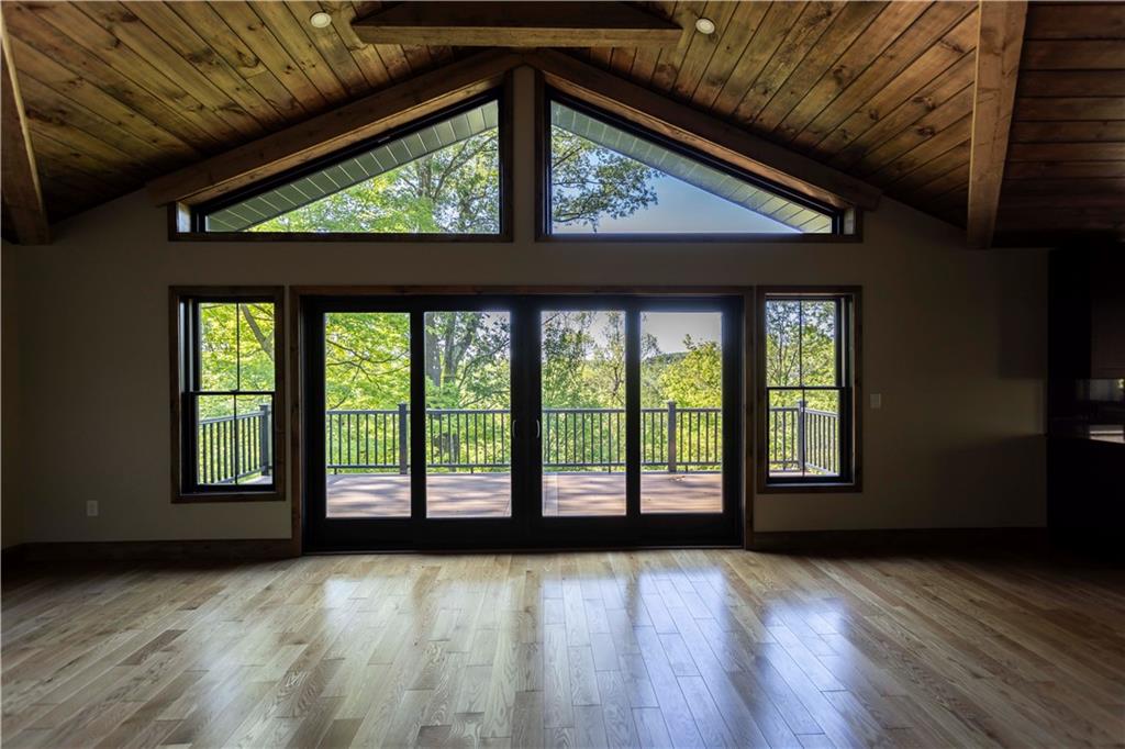 181 Alpine Heights Road Champion, PA 15622 - Photo 5 of 49 a view of an empty room with wooden floor and a window