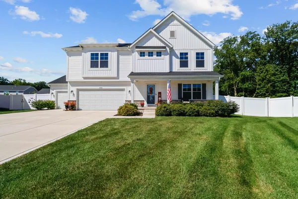 a front view of house with yard and green space