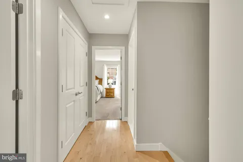 a view of a hallway with wooden floor