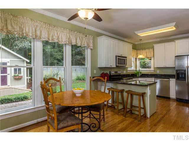 2637 Jasper Lane Raleigh, NC 27613 - Photo 8 of 25 a dining room with furniture and a floor to ceiling window