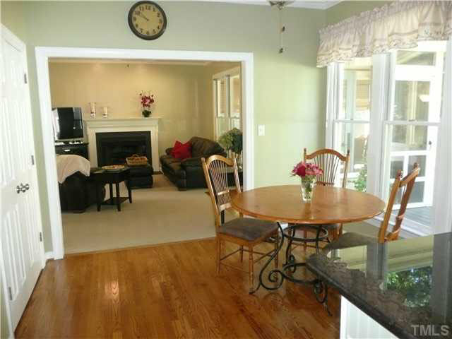 2637 Jasper Lane Raleigh, NC 27613 - Photo 10 of 25 a view of a dining room with furniture and a fireplace