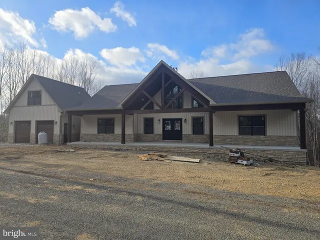 a front view of a house with parking space