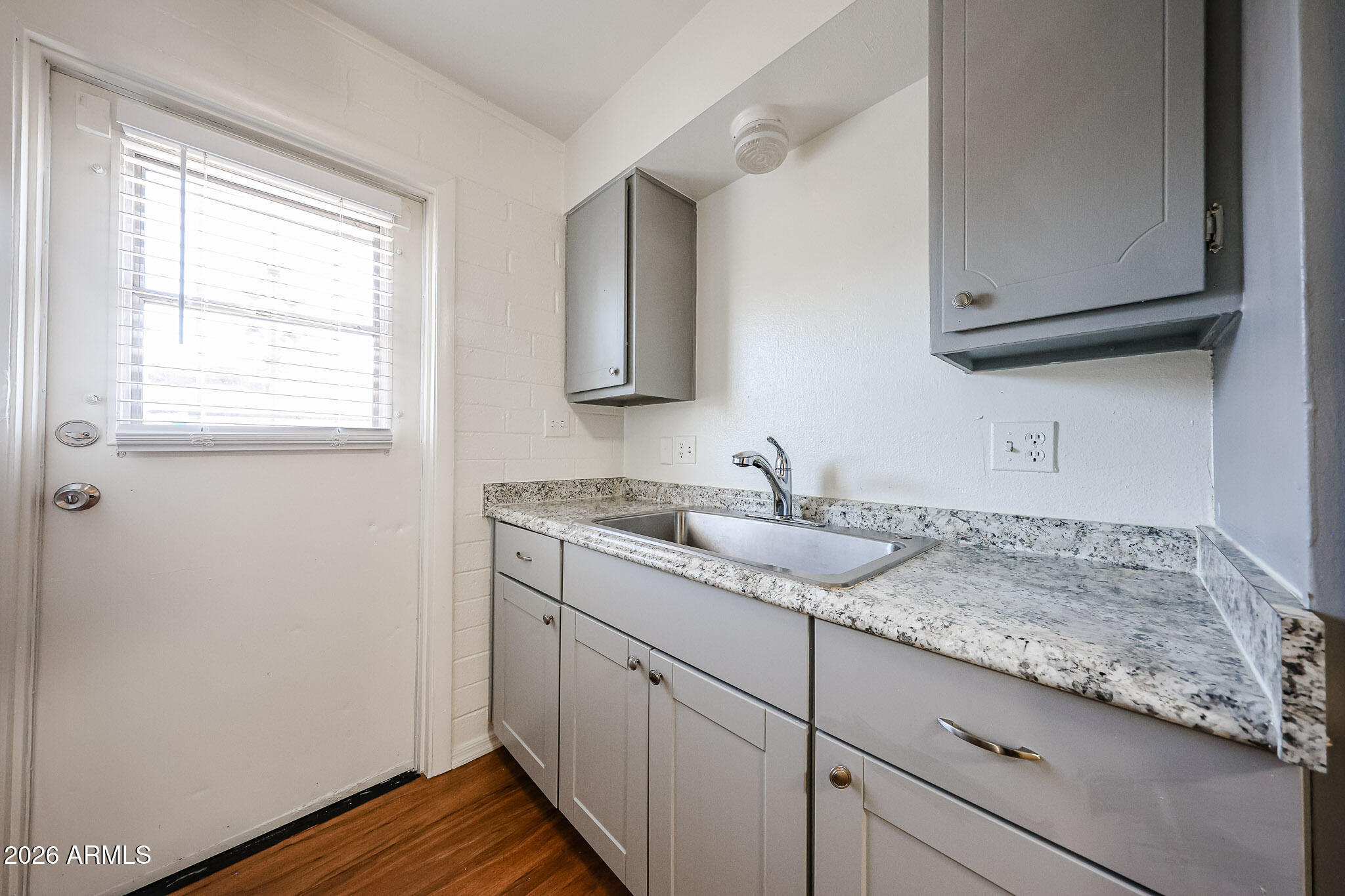 2226 West Heatherbrae Drive, Unit 4 Phoenix, AZ 85015 - Photo 11 of 17 a bathroom with a granite countertop sink and a mirror