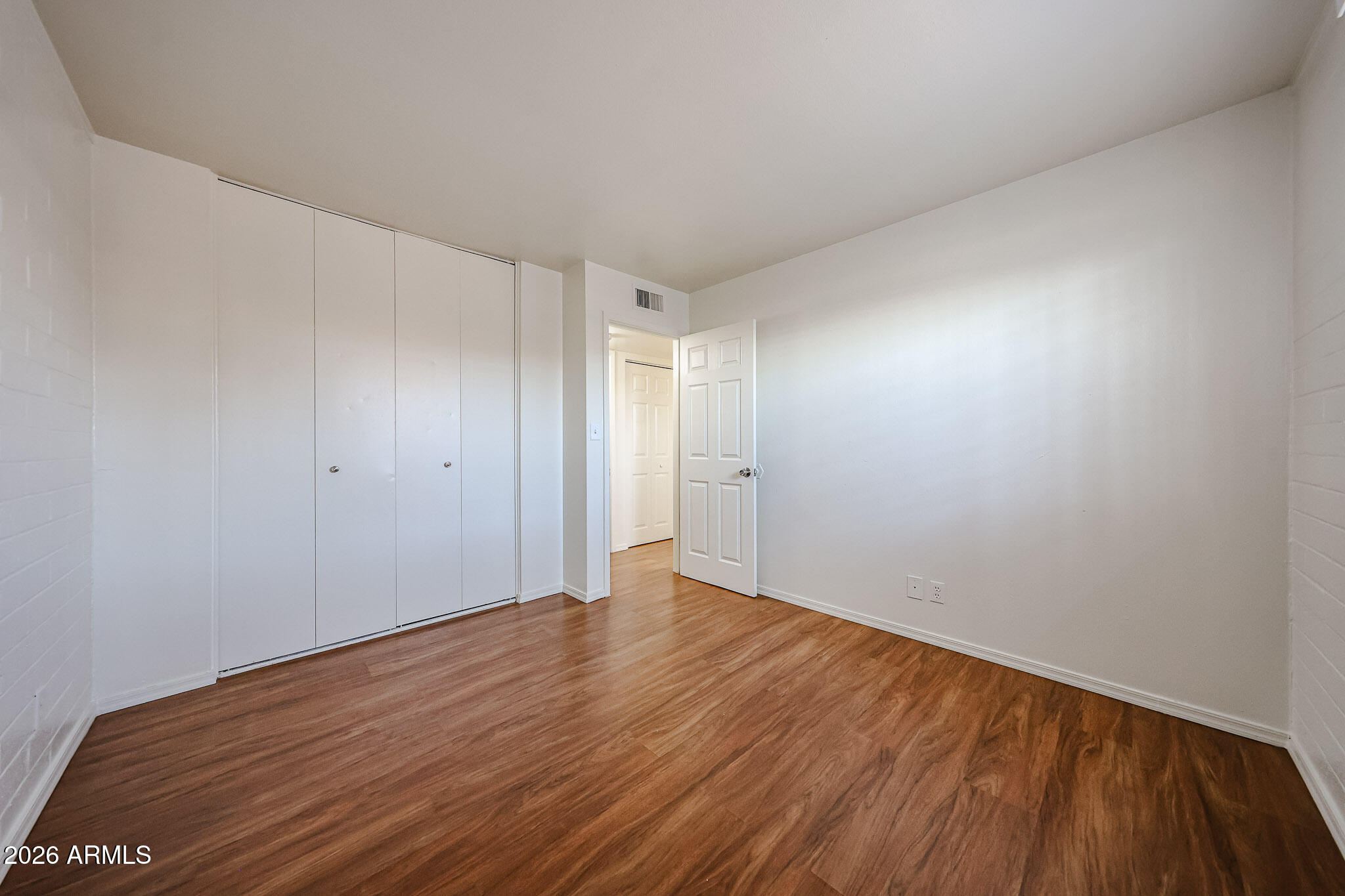 2226 West Heatherbrae Drive, Unit 4 Phoenix, AZ 85015 - Photo 16 of 17 a view of an empty room with wooden floor