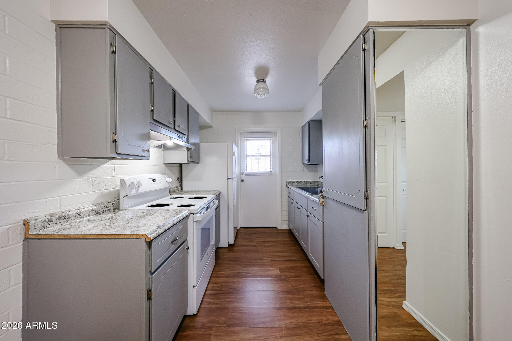 2226 West Heatherbrae Drive, Unit 4 Phoenix, AZ 85015 - Photo 9 of 17 a kitchen with stainless steel appliances granite countertop a stove a sink and a refrigerator