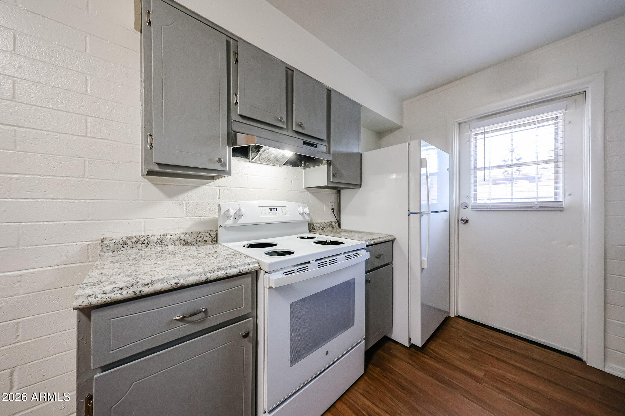 2226 West Heatherbrae Drive, Unit 4 Phoenix, AZ 85015 - Photo 10 of 17 a kitchen with granite countertop a sink stove and refrigerator