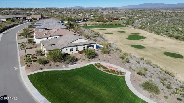 an aerial view of a house with a yard