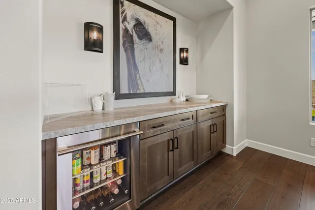 a utility room with stainless steel appliances wooden floor and sink