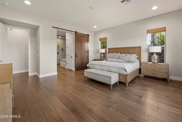 a spacious bedroom with a bed and a table