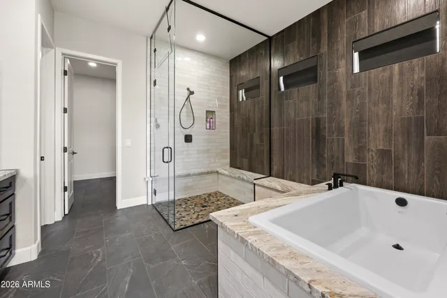 a bathroom with a tub sink and shower