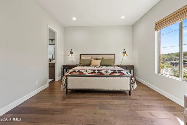 a bed room with a bed and a large window