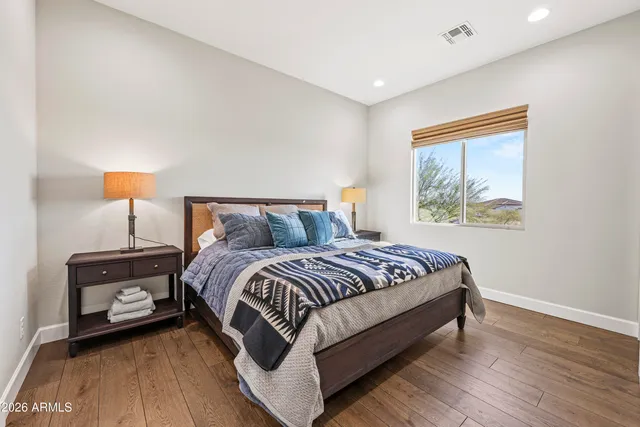 a bedroom with a bed and a night stand