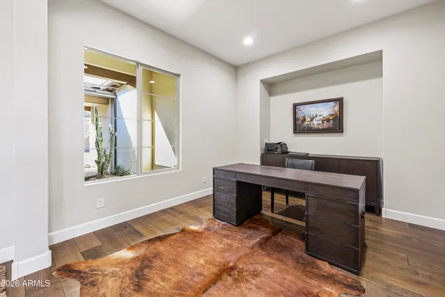 a view of room with window and wooden floor