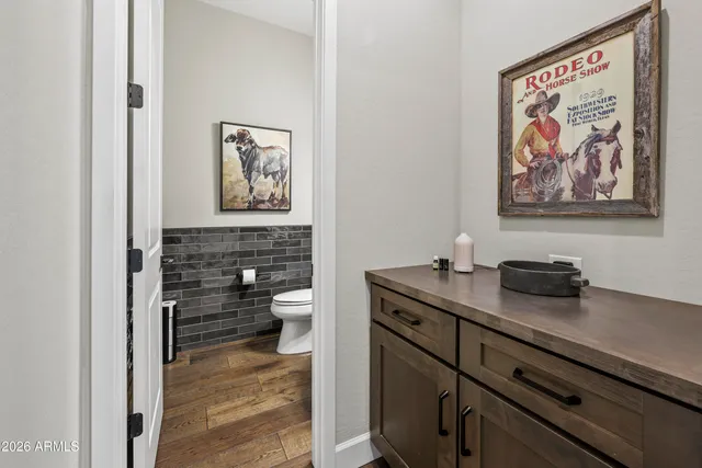 a bathroom with a toilet a sink and mirror