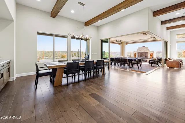 a dining room with a wooden table and chairs