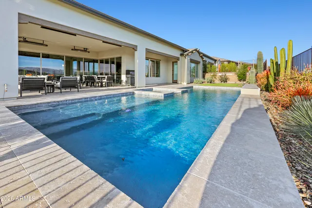 a view of a swimming pool with a lounge chair