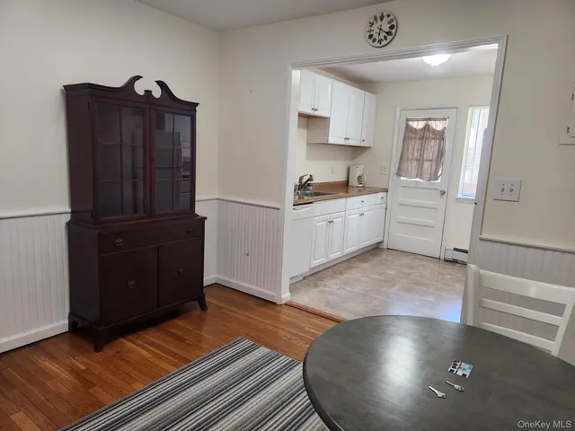 a kitchen with granite countertop a refrigerator and a stove top oven