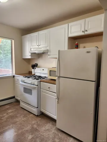 a white refrigerator freezer sitting in a kitchen