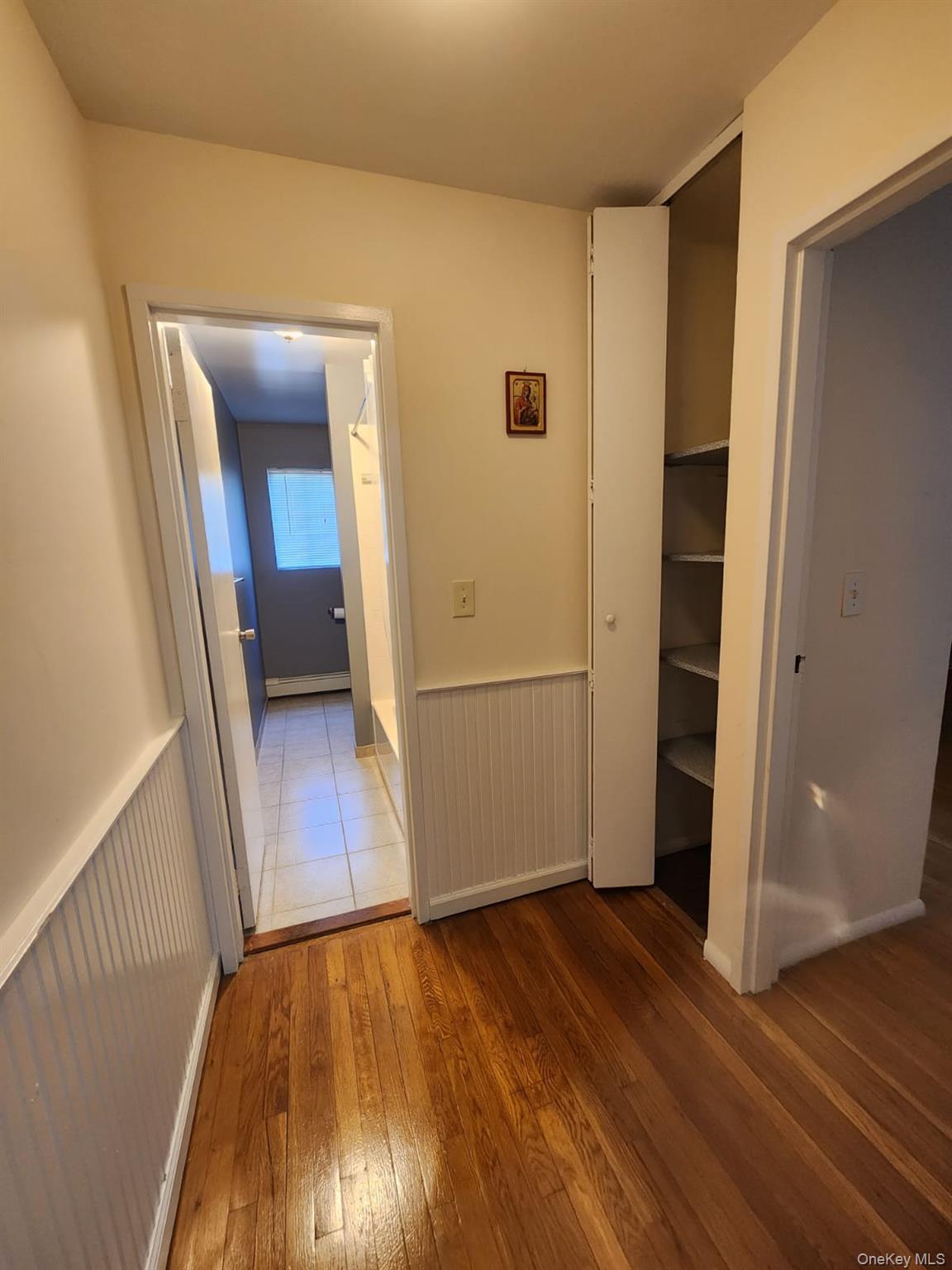 3 Hook Road, Unit 64C Poughkeepsie, NY 12601 - Photo 10 of 15 a view of a hallway to an empty room with wooden floor and stairs