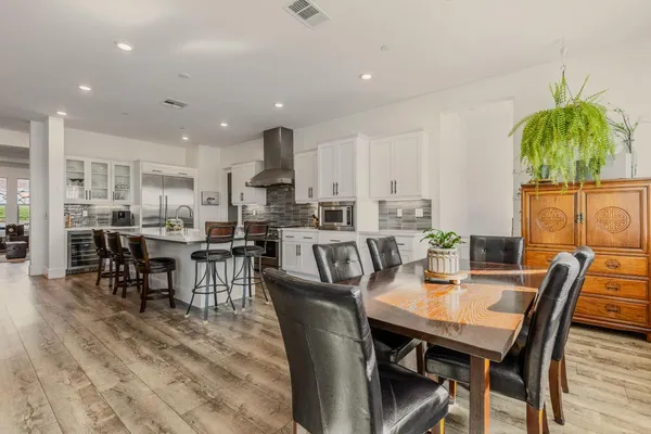 a view of a dining room with furniture and chandelier