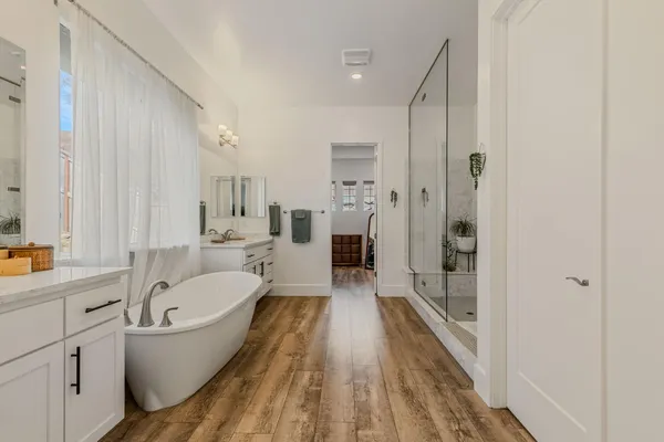 a spacious bathroom with a bathtub and a shower