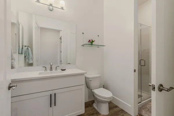 a bathroom with a sink toilet and shower