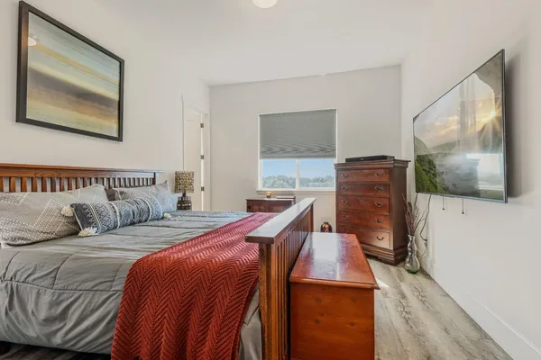 a bedroom with a bed and a flat screen tv