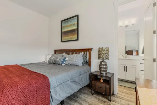 a bedroom with a bed and a table