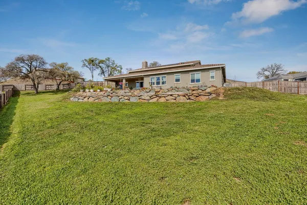 a view of a big yard with table and chairs