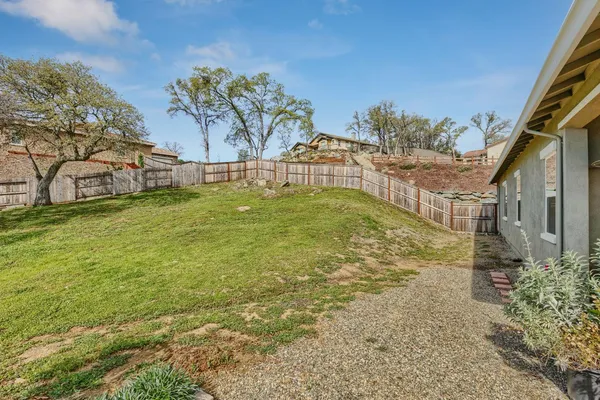 a view of a yard with yellow house