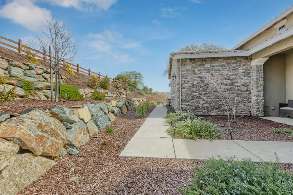 a view of a pathway both side of house