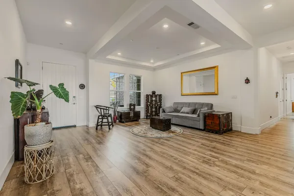 a living room with furniture and wooden floor