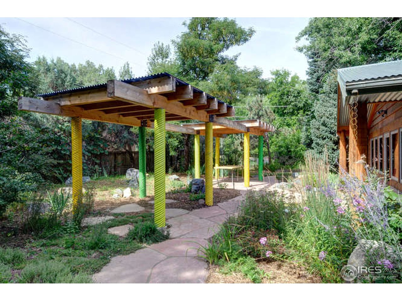 751 Gapter Road Boulder, CO 80303 - Photo 20 of 24 a view of a patio with table and chairs under an umbrella