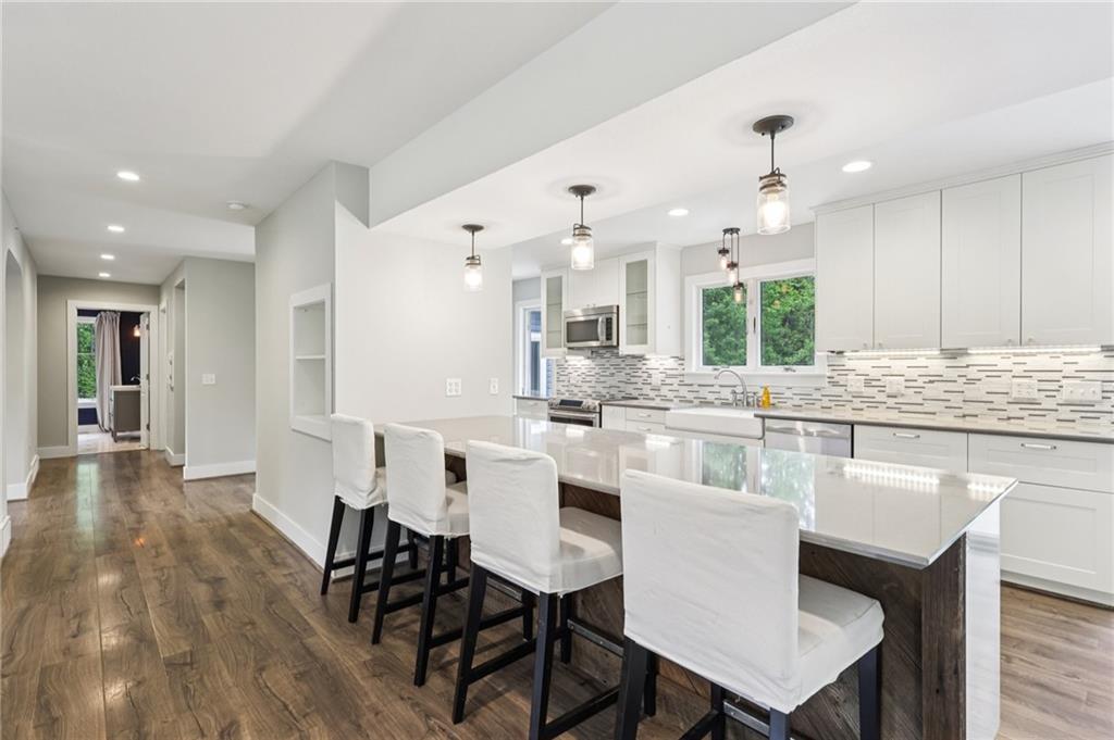3442 Mercer Road New Castle, PA 16105 - Photo 9 of 39 a large white kitchen with a table and chairs