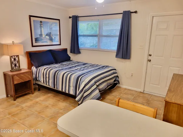 a bedroom with a bed and window