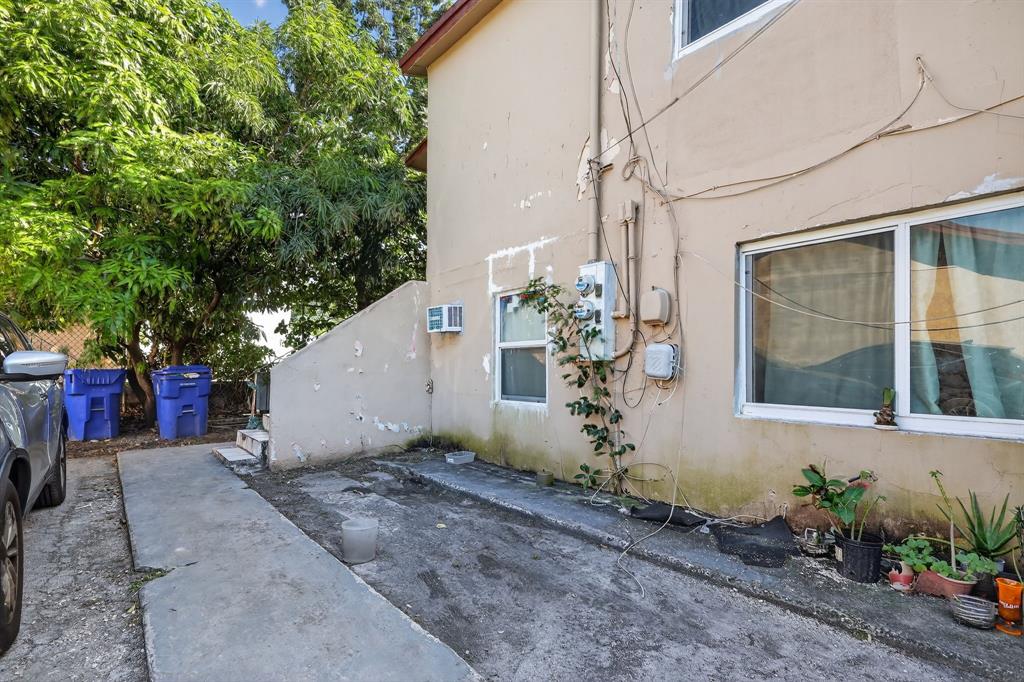 2168 Northwest 28th Street Miami, FL 33142 - Photo 5 of 31 a view of a house with a yard and potted plants