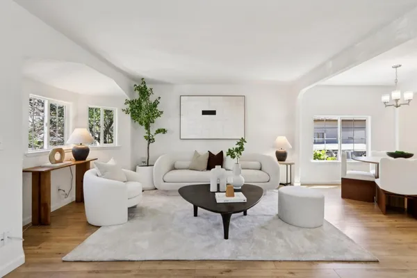 a living room with furniture a rug and a large window