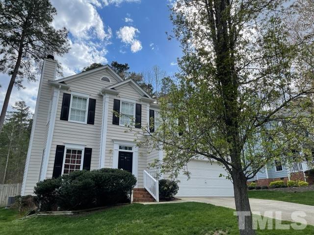 311 Catlin Road Cary, NC 27519 - Photo 3 of 3 a front view of a house with a garden and trees
